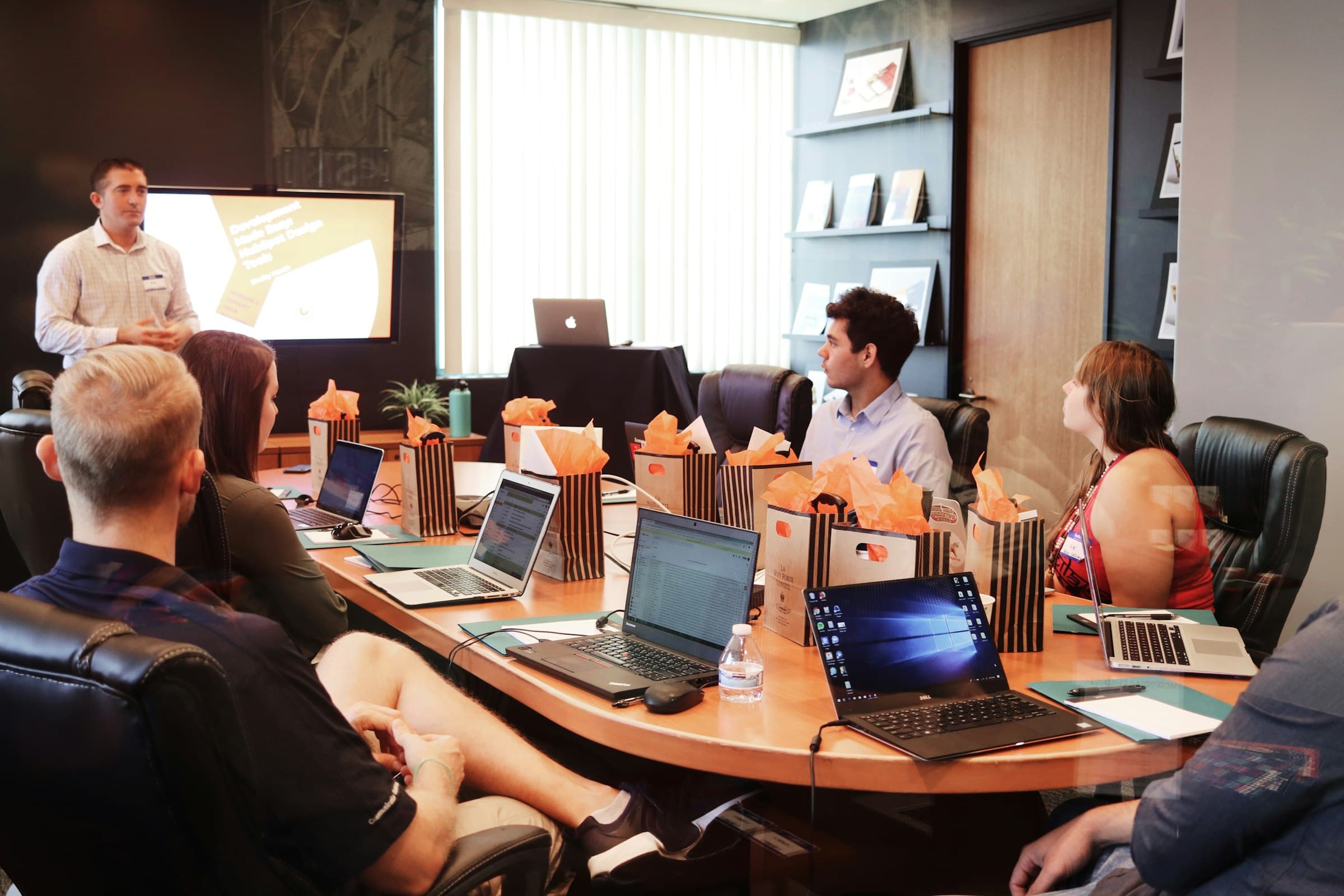A team reviews the numbers together on a meeting-room screen